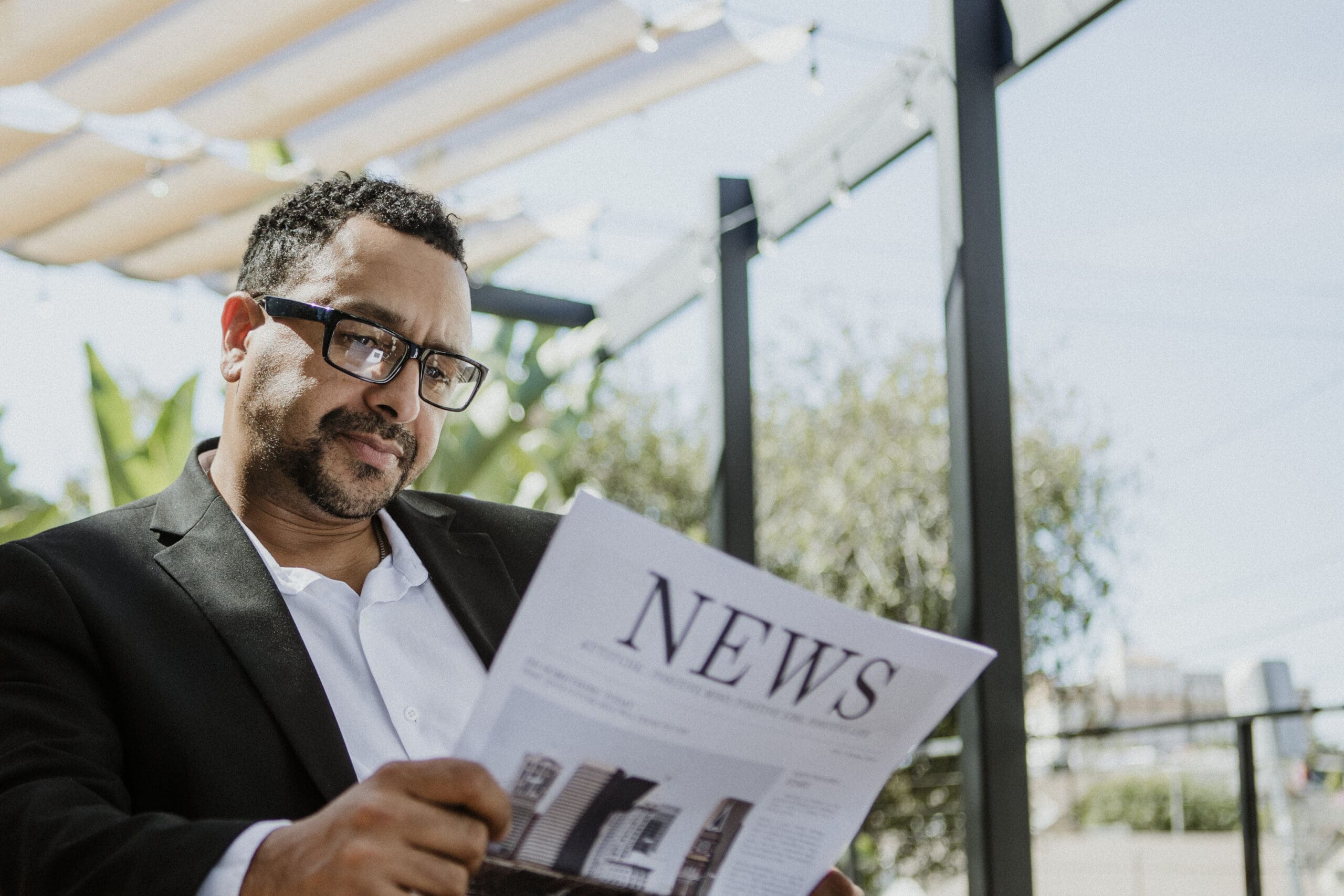 Businessman reading a newspaper in a cafe